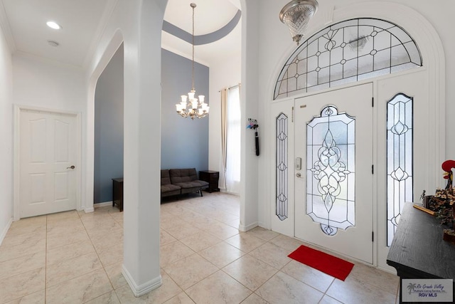 foyer entrance with light tile patterned floors and a notable chandelier