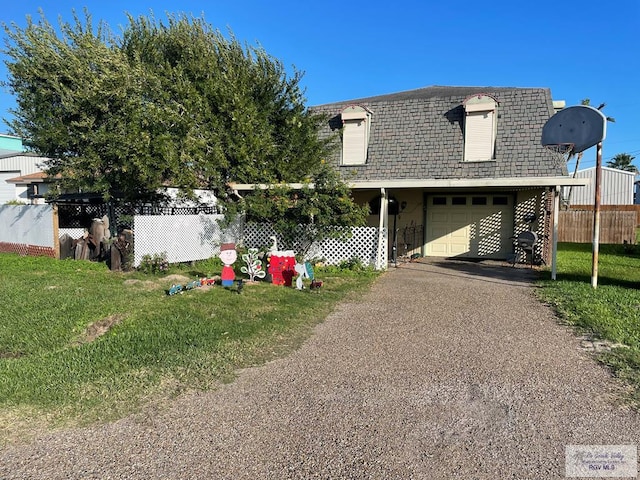 view of front of property with a front yard and a garage