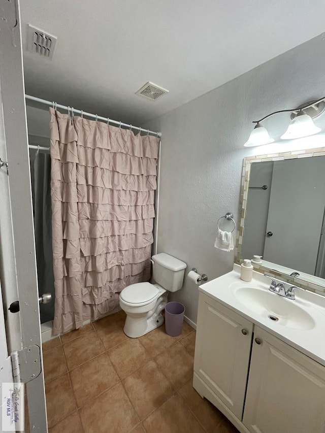 bathroom with a shower with shower curtain, vanity, toilet, and tile patterned flooring