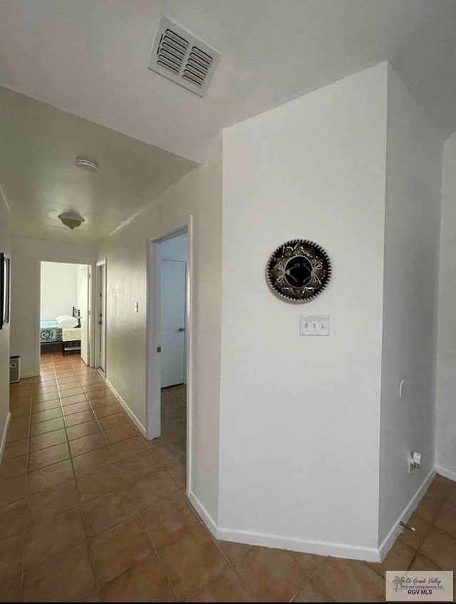 hallway with tile patterned flooring