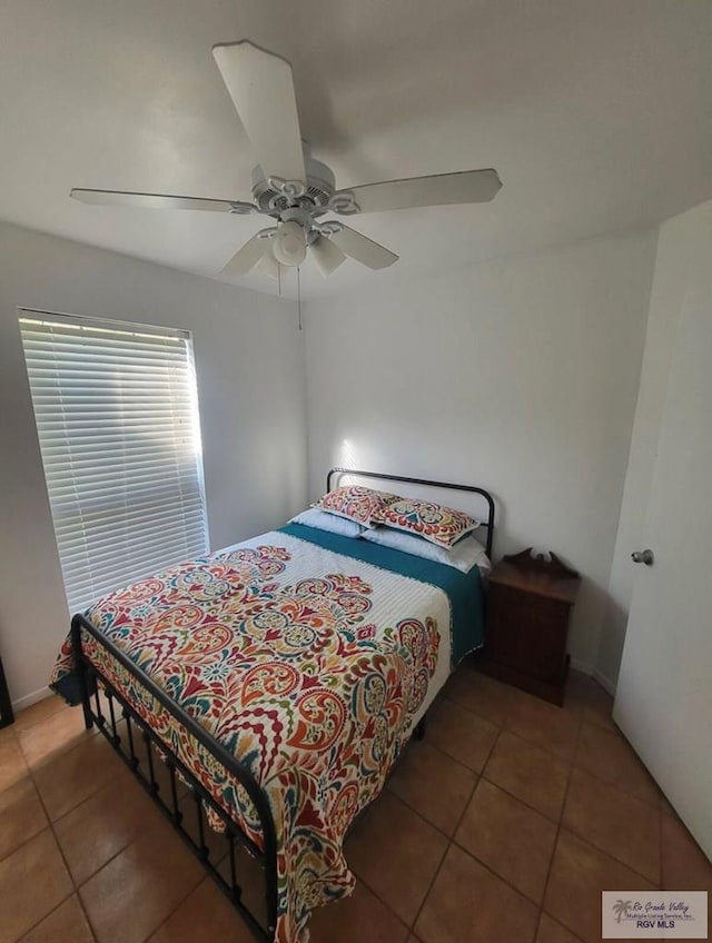 bedroom with tile patterned floors and ceiling fan