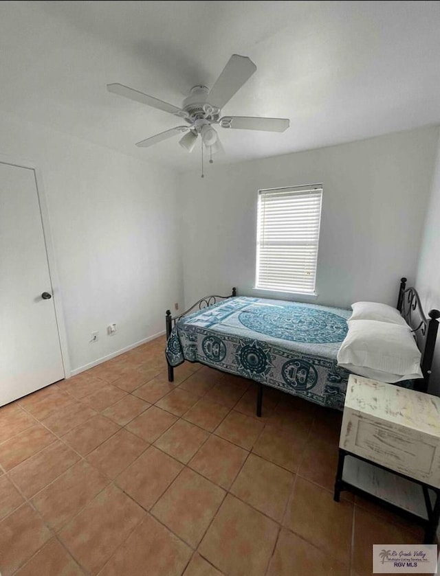 bedroom featuring tile patterned floors and ceiling fan