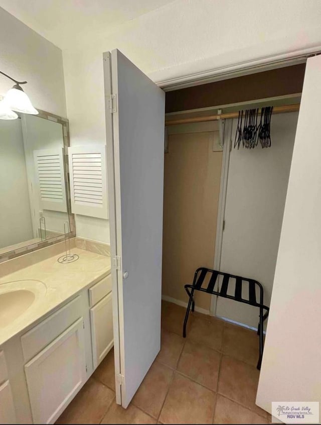 bathroom with tile patterned flooring and vanity