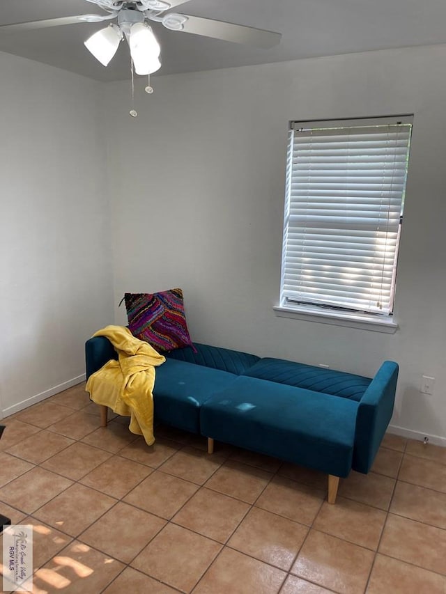 sitting room featuring ceiling fan and light tile patterned flooring