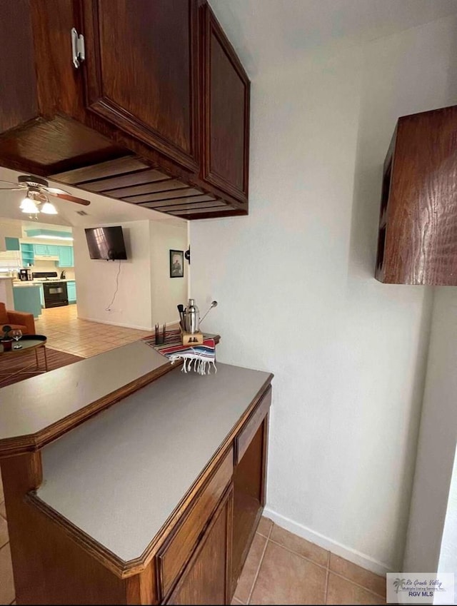 kitchen featuring ceiling fan and light tile patterned floors