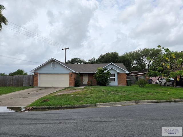 4727 Las Palomas St, Brownsville, TX 78521 - single story home with brick siding, concrete driveway, and a garage