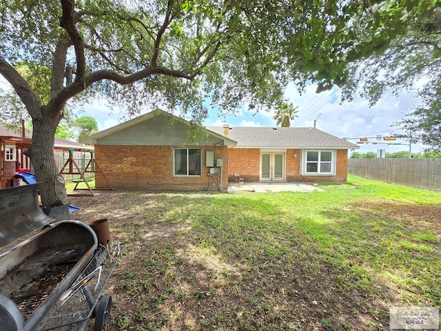 4727 Las Palomas St, Brownsville, TX 78521 - rear view of house with a fenced backyard, a patio, and brick siding