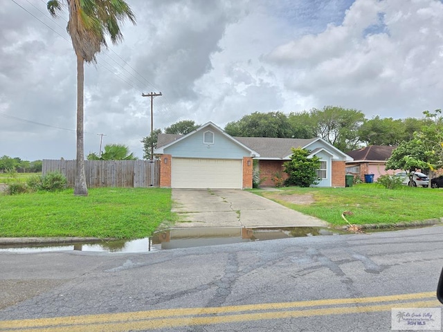 4727 Las Palomas St, Brownsville, TX 78521 - ranch-style home featuring driveway, a garage, and brick siding