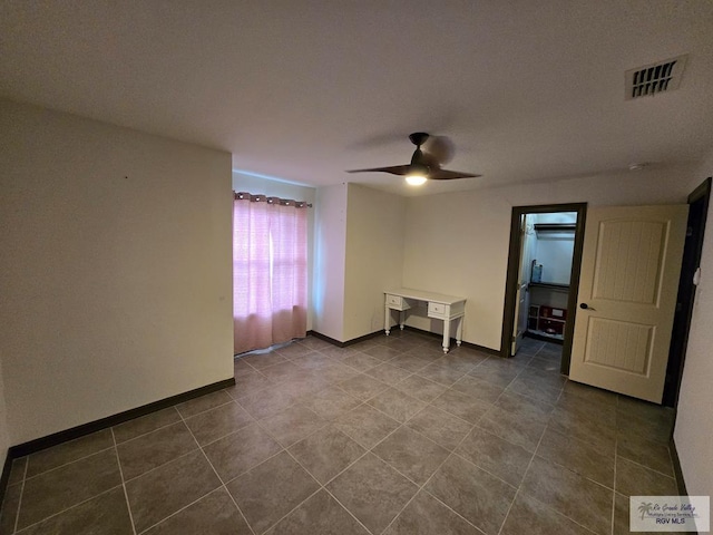 4727 Las Palomas St, Brownsville, TX 78521 - spare room with a ceiling fan and dark tile patterned flooring