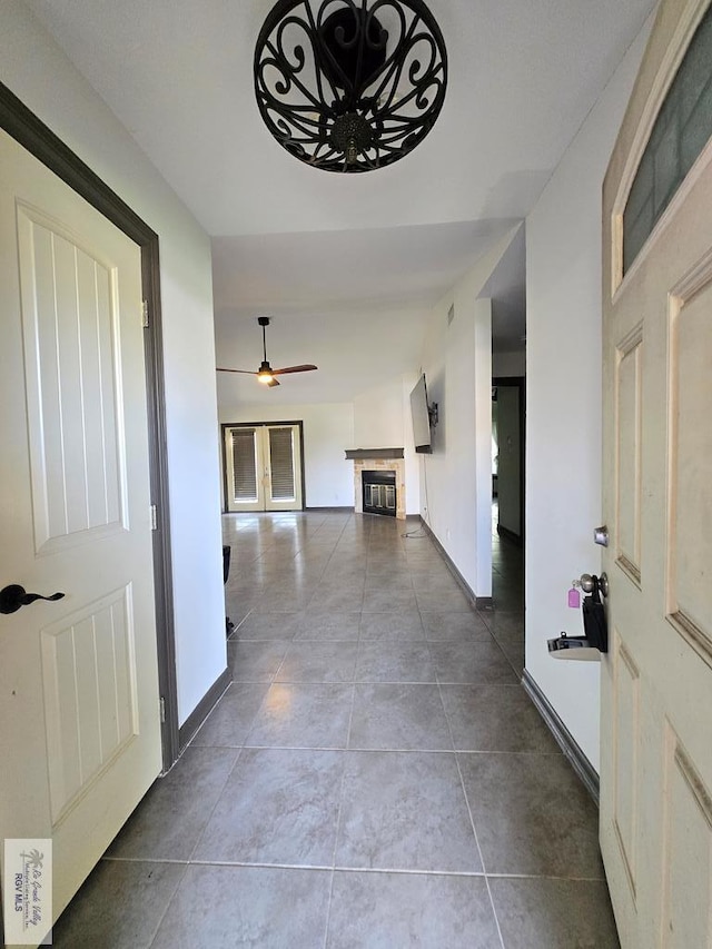 4727 Las Palomas St, Brownsville, TX 78521 - tiled foyer featuring a tiled fireplace and ceiling fan