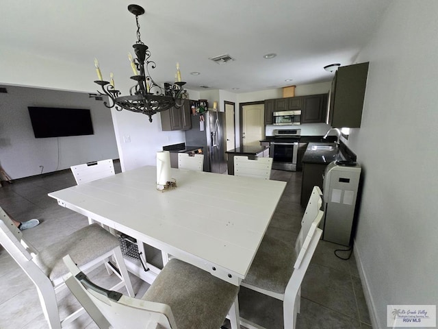 4727 Las Palomas St, Brownsville, TX 78521 - dining area with a chandelier and baseboards