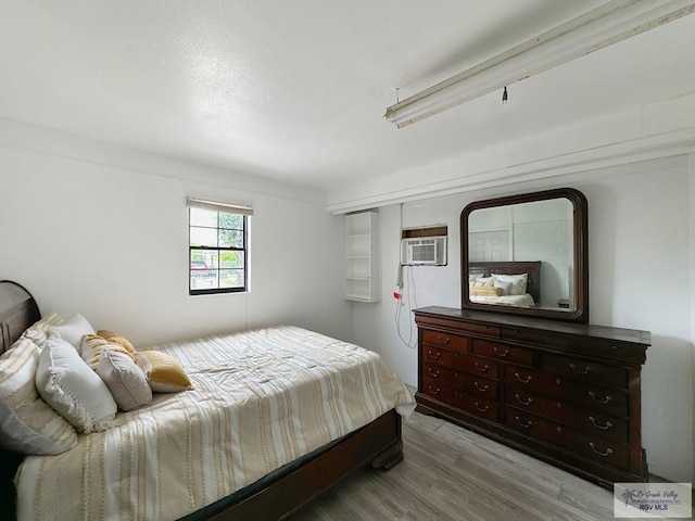 700 N Illinois Ave, Weslaco, TX 78596 - bedroom featuring wood finished floors and a wall mounted AC