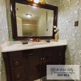 bathroom with a shower with door and vanity