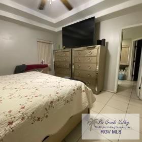 tiled bedroom with ceiling fan