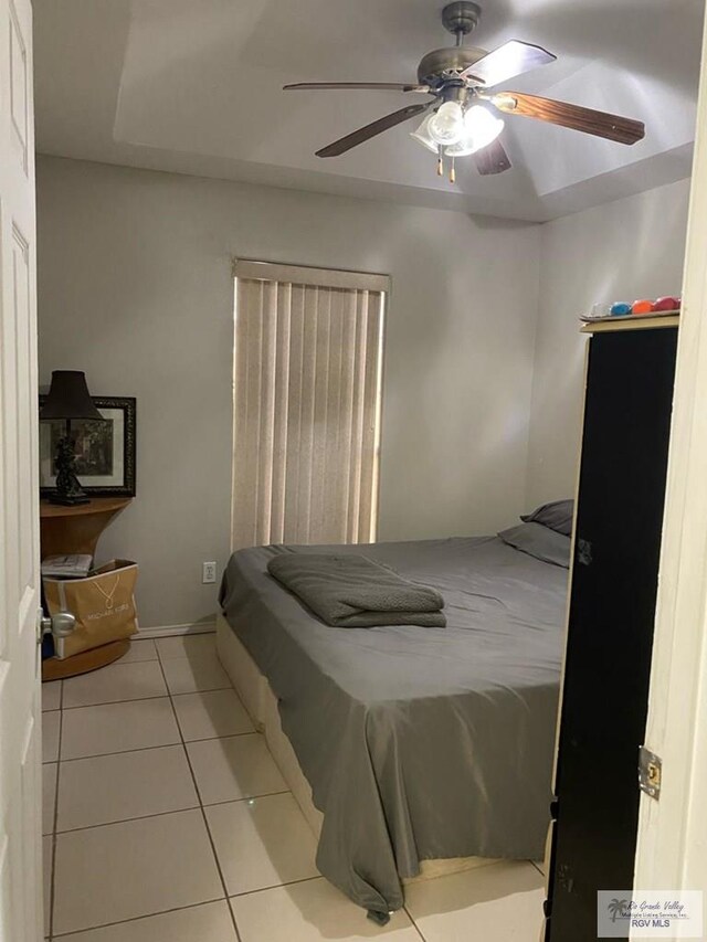 tiled bedroom with ceiling fan