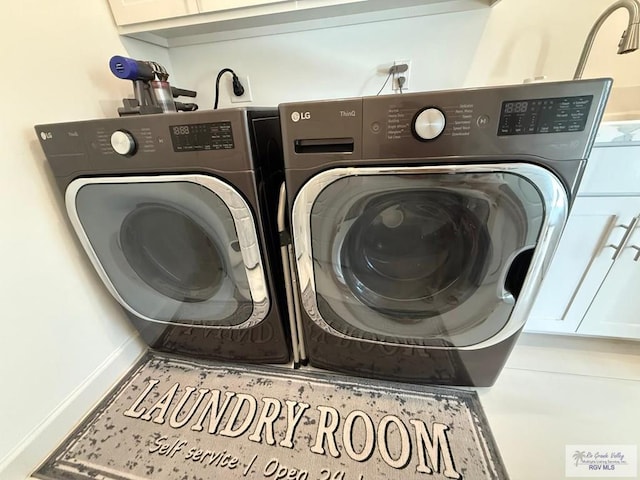 1992 Lulu St, Brownsville, TX 78577 - laundry area featuring washer and clothes dryer and cabinet space