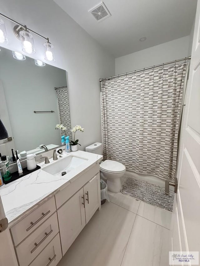 1992 Lulu St, Brownsville, TX 78577 - bathroom featuring toilet, vanity, a shower with shower curtain, and tile patterned floors