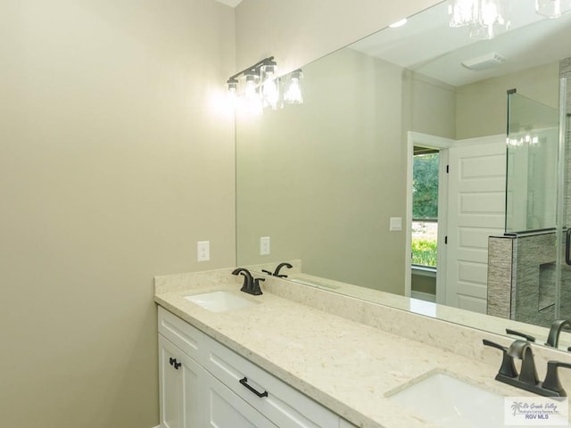 bathroom with vanity and a shower with door