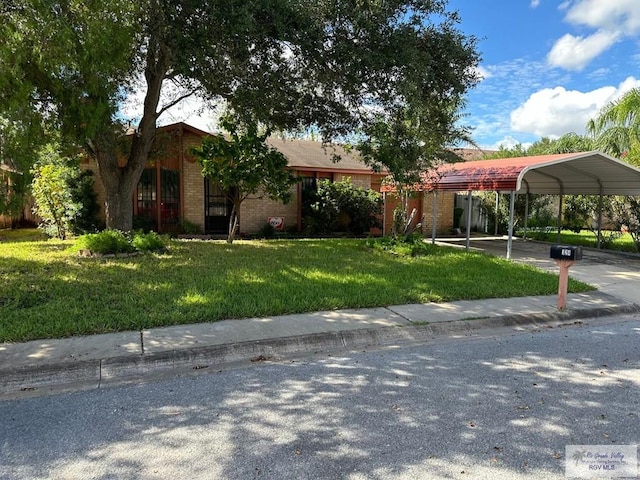 view of front of house with a carport and a front lawn