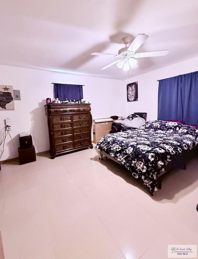 bedroom featuring tile patterned floors and a ceiling fan