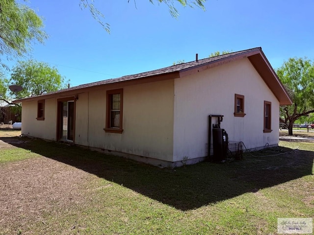 view of property exterior with a lawn
