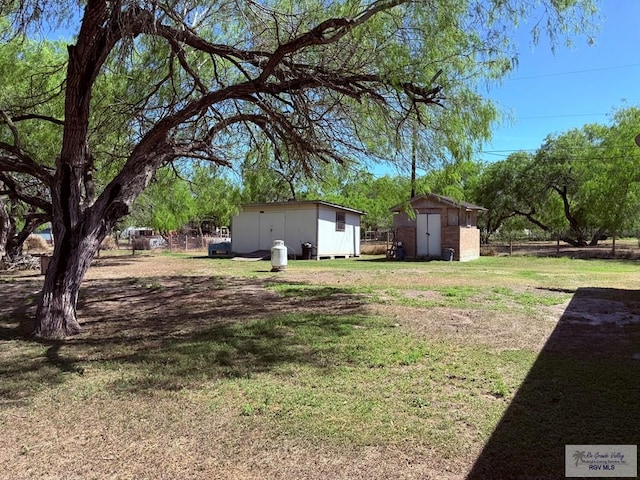 view of yard featuring an outbuilding and a shed