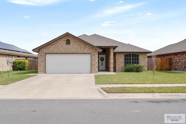 single story home with a garage and a front lawn