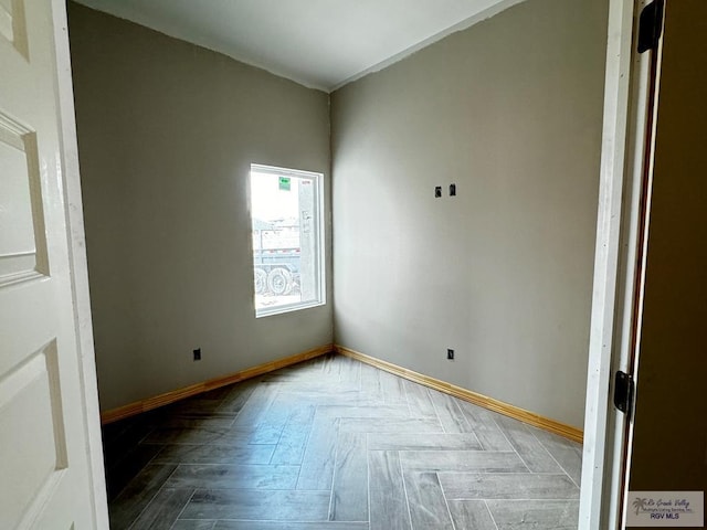 spare room featuring parquet floors