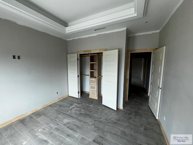 unfurnished bedroom featuring a closet and ornamental molding