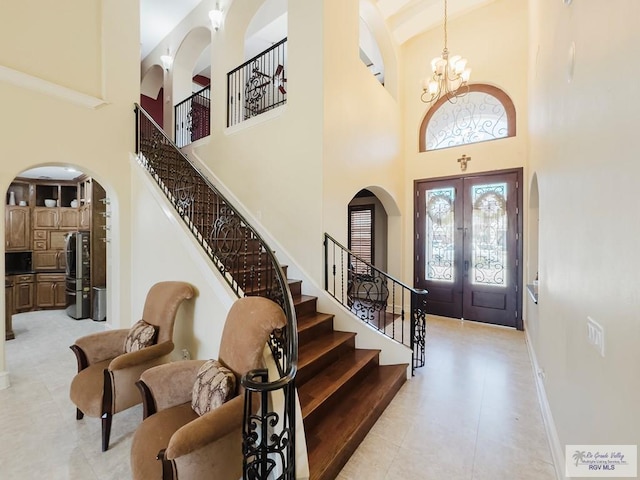 2410 E 21st St, Mission, TX 78572 - entryway featuring arched walkways, a high ceiling, french doors, and stairs