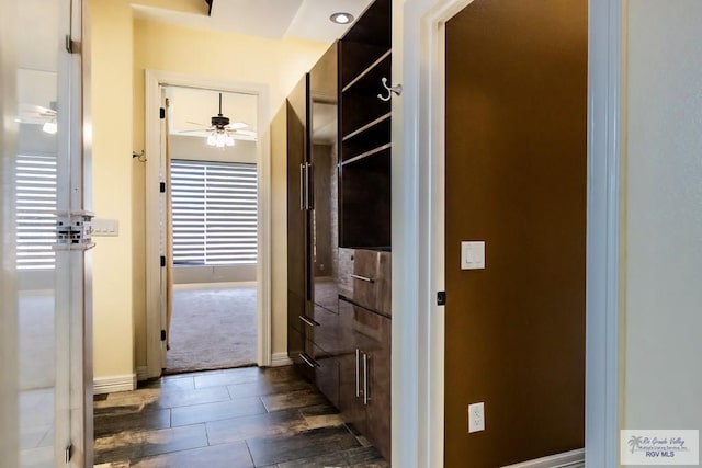 2410 E 21st St, Mission, TX 78572 - corridor with baseboards and dark carpet
