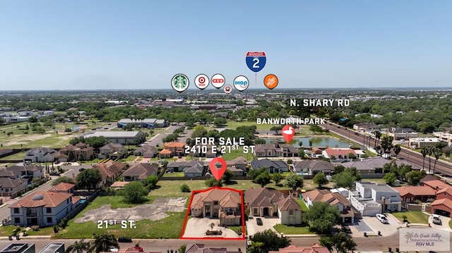 2410 E 21st St, Mission, TX 78572 - aerial perspective of suburban area with property parcel outlined and a nearby body of water