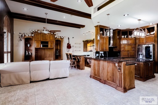 2410 E 21st St, Mission, TX 78572 - kitchen featuring ceiling fan, stainless steel fridge with ice dispenser, a peninsula, a kitchen breakfast bar, and pendant lighting