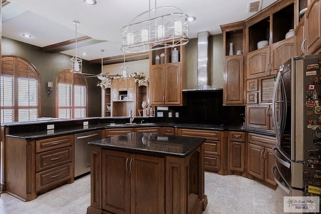 2410 E 21st St, Mission, TX 78572 - kitchen with stainless steel appliances, a peninsula, a sink, a chandelier, and wall chimney exhaust hood
