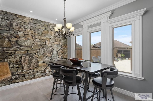 dining space featuring a chandelier, a wealth of natural light, and crown molding