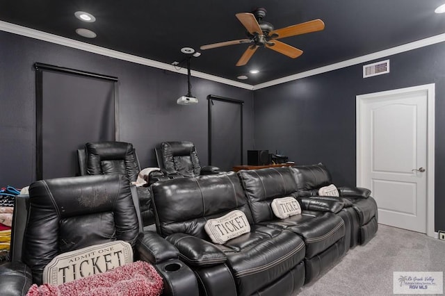 carpeted home theater featuring ceiling fan and crown molding