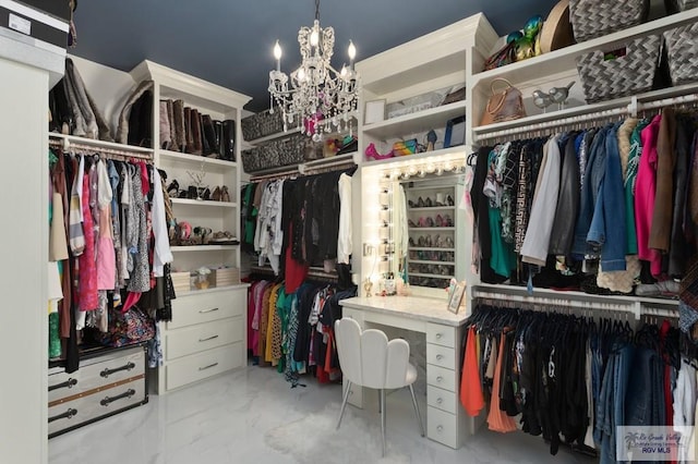 walk in closet with a notable chandelier