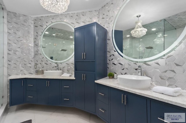 bathroom featuring a notable chandelier, walk in shower, and vanity