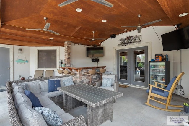 view of patio / terrace with an outdoor living space, french doors, and ceiling fan