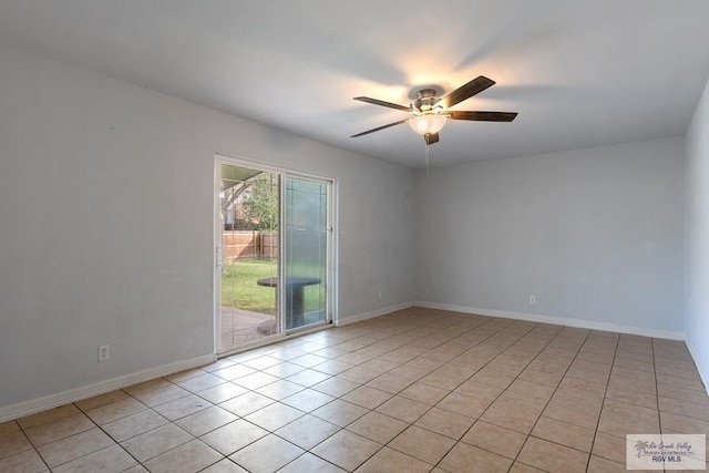 tiled empty room featuring ceiling fan