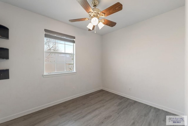 spare room featuring hardwood / wood-style flooring and ceiling fan