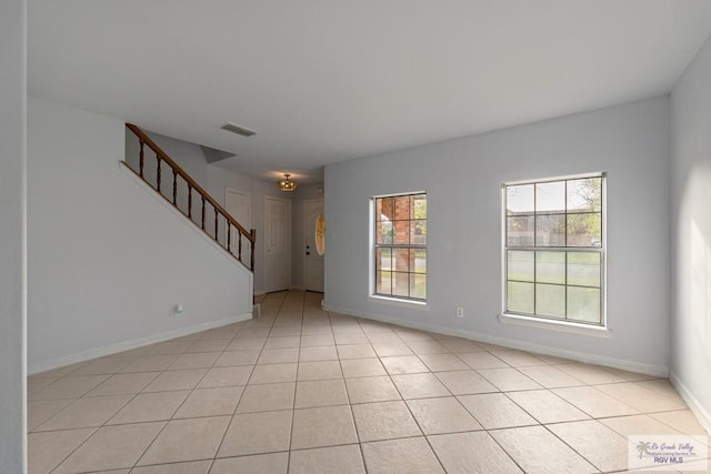 unfurnished living room featuring light tile patterned flooring