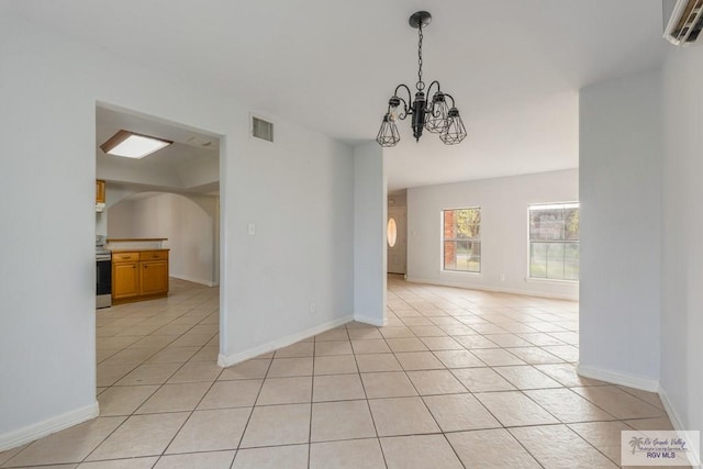 unfurnished dining area featuring light tile patterned flooring and an inviting chandelier