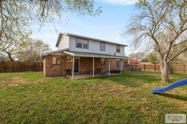 back of house featuring a lawn, a playground, and a patio area