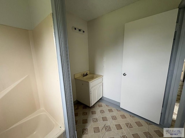 bathroom featuring a bath and vanity