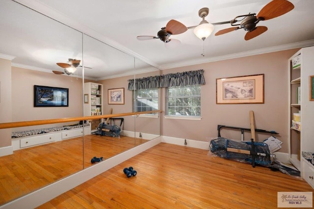 workout room with wood-type flooring and ornamental molding