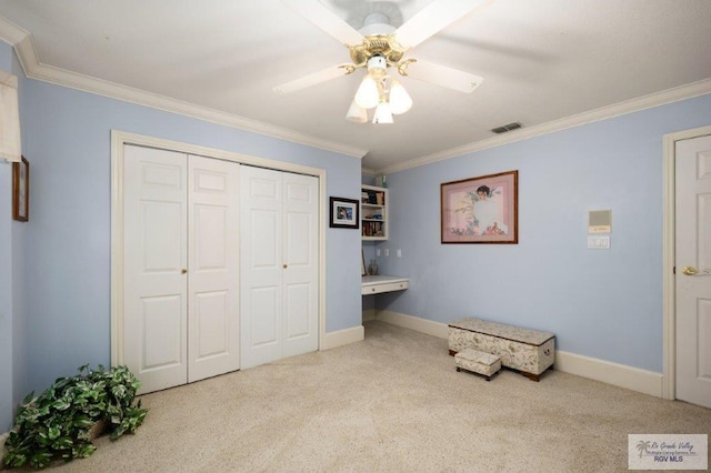 living area with crown molding, ceiling fan, and light carpet