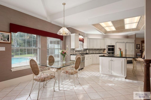 unfurnished dining area featuring vaulted ceiling, sink, ornamental molding, and light tile patterned floors