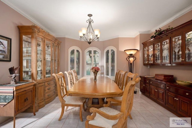 tiled dining space with ornamental molding and an inviting chandelier