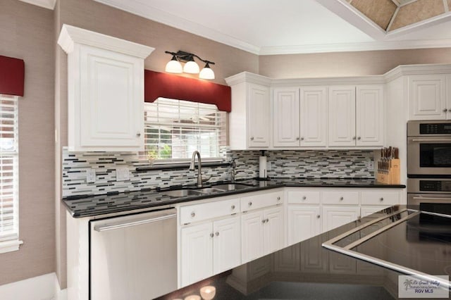 kitchen featuring white cabinetry, sink, tasteful backsplash, and stainless steel appliances